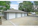 Three-car garage with white doors and ample parking space at 2213 Emery St # C, Longmont, CO 80501