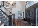 Grand foyer with curved staircase and hardwood floors at 904 S Wiley Ct, Superior, CO 80027