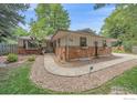 Ranch-style home with stone exterior and landscaped yard at 3501 Kirkwood Pl, Boulder, CO 80304