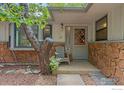 Front entrance with stonework, a gray door, and a comfortable chair at 3501 Kirkwood Pl, Boulder, CO 80304