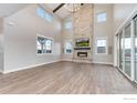 Spacious living room with a stone fireplace and hardwood floors at 22 Parkstone Ct, Berthoud, CO 80513