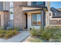 Modern front entrance with stone and gray siding at 9284 Gore St # D, Arvada, CO 80007