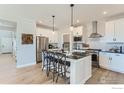 Modern kitchen with white cabinets, large island, and stainless steel appliances at 2731 Crystal Springs Ln, Longmont, CO 80503