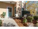 Small patio with chairs and plants in front of condo entrance at 2645 Tabriz Pl # 11, Boulder, CO 80304