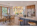 Modern kitchen with island, stainless steel appliances, and wood cabinetry at 225 Bristlecone Way, Boulder, CO 80304