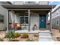 Front view of a charming two-story house with a welcoming porch and landscaping at 1135 Hummingbird Cir, Longmont, CO 80501