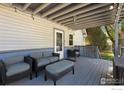 Relaxing back patio with comfortable seating and a view of the backyard at 1110 Hover St, Longmont, CO 80501