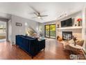 Spacious living room with hardwood floors, fireplace, and access to a balcony at 3785 Birchwood Dr # 72, Boulder, CO 80304