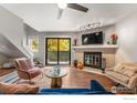 Living room with fireplace, hardwood floors, and access to a private balcony at 3785 Birchwood Dr # 72, Boulder, CO 80304