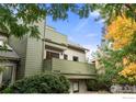 Contemporary townhome with a green exterior and balcony at 3785 Birchwood Dr # 72, Boulder, CO 80304