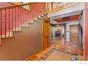 Elegant staircase with wrought iron railings and tiled steps at 1600 17Th Ave, Longmont, CO 80501
