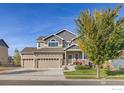 Two-story house with three car garage and landscaped yard at 514 Mount Rainier St, Berthoud, CO 80513