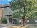 Green two-story building with stone accents and landscaping at 3345 Chisholm Trl # 105C, Boulder, CO 80301