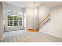 Bright living room with high ceilings, fireplace, and hardwood floors at 236 Remuda Ln, Lafayette, CO 80026