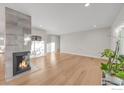 Modern fireplace with gray tile surround in living room at 3955 S Uinta St, Denver, CO 80237