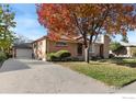 Ranch style home with attached garage and mature landscaping at 1980 Samuel Dr, Denver, CO 80221