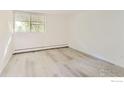 Simple bedroom with light wood floors and a window at 2707 Valmont Rd # 110B, Boulder, CO 80304