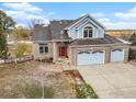 Two-story house with light blue exterior, double garage, and driveway at 18715 Wagon Trl, Mead, CO 80542