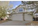 Two-story home with attached two-car garage and front porch at 5462 S Valdai Way, Aurora, CO 80015