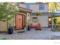 Inviting front entrance with a pergola and red chairs, leading to a home with a wood-like exterior at 3737 26Th St, Boulder, CO 80304