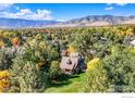 Aerial view of a charming house nestled amongst colorful autumn foliage, with mountains in the background at 3737 26Th St, Boulder, CO 80304