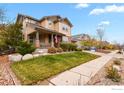 Two-story house with front porch and landscaped yard at 1138 Lasnik St, Erie, CO 80516