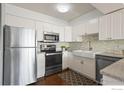 Modern kitchen featuring white cabinets, stainless steel appliances, and a farmhouse sink at 1850 Folsom St # 204, Boulder, CO 80302