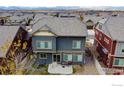 Rear view of house showing patio and surrounding houses at 185 Pipit Lake Way, Erie, CO 80516