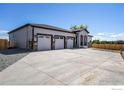 Ranch-style home with three-car garage and large driveway at 7292 Xenophon Ct, Arvada, CO 80005