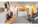Open living room with view to kitchen and dining area at 13708 Legend Trl # 101, Broomfield, CO 80023