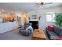 Living room with gray couches, a recliner, and a view of the kitchen at 13708 Legend Trl # 101, Broomfield, CO 80023