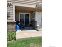 Small patio area with seating for two and outdoor lighting at 1601 Great Western Dr, Longmont, CO 80501