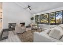 Living room with a fireplace, large windows, and light flooring at 612 S Bermont Ave, Lafayette, CO 80026