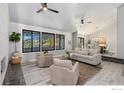 Open living room with vaulted ceiling, fireplace, and large windows at 612 S Bermont Ave, Lafayette, CO 80026