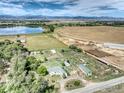 Aerial view of a house on acreage with mountain views and agricultural features at 14619 N 115Th St, Longmont, CO 80504