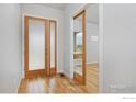 Light and airy entryway with hardwood floors and frosted glass door at 2292 Star Hill St, Longmont, CO 80503