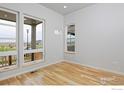 Bright living room with hardwood floors and large windows at 2292 Star Hill St, Longmont, CO 80503