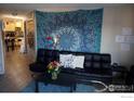 Living room features a black couch and a large tapestry at 903 18Th St # 302, Boulder, CO 80302