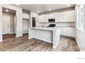 Modern kitchen featuring white cabinets, stainless steel appliances, and an island at 16870 Mckay Dr, Mead, CO 80542