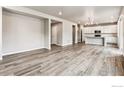 Open concept living room with light wood flooring and neutral color scheme at 16870 Mckay Dr, Mead, CO 80542