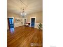 Elegant dining room with hardwood floors and chandelier at 203 S 3Rd Ave, Brighton, CO 80601