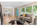 Living room with hardwood floors, stylish decor, and a view of the backyard at 2541 S Clermont St, Denver, CO 80222