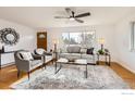 Bright living room with hardwood floors, comfortable seating and large windows at 3520 W County Road 8, Berthoud, CO 80513