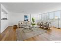 Living room with hardwood floors, neutral colored couch and chairs, and a coffee table at 1850 Folsom St # 611, Boulder, CO 80302