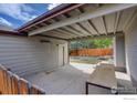Covered patio with a concrete slab and backyard access at 1980 Ruth Dr, Thornton, CO 80229
