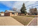 Front view of a ranch home with a driveway and yard at 8350 Tennyson St, Westminster, CO 80031