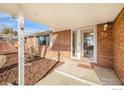 Covered front porch entry to brick rancher at 32 University Dr, Longmont, CO 80503