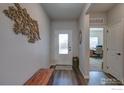 Bright and spacious entryway with an open floor plan and view into the home office at 14817 Longhorn Dr, Mead, CO 80542
