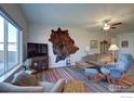 Cozy living room featuring a large TV, comfortable seating, and a stylish rug at 14817 Longhorn Dr, Mead, CO 80542