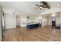 Open concept kitchen with island, white cabinets, and stainless steel appliances at 0 Hwy 52, Erie, CO 80516
